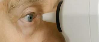 Close-up of an elderly person’s eye being examined with a tonometer during intraocular pressure measurement, medical diagnostic scene.